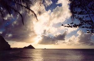 Santa Lucia, sun behind clouds, ocean, mountains, foliage