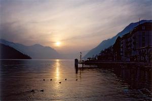 Sunset over Brunnen lake, mountains and town