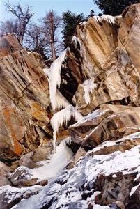 Frozen waterfall on rocks - ice stalagmites